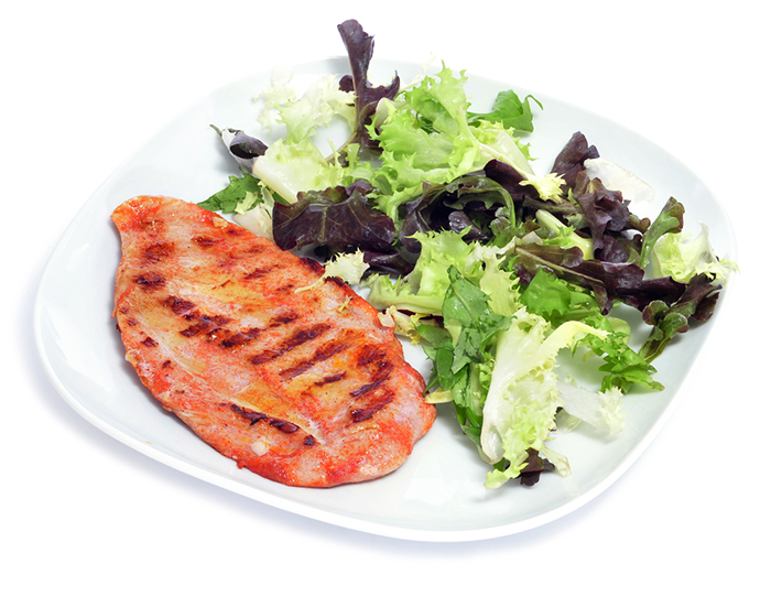 a plate with grilled chicken and green salad on a white background